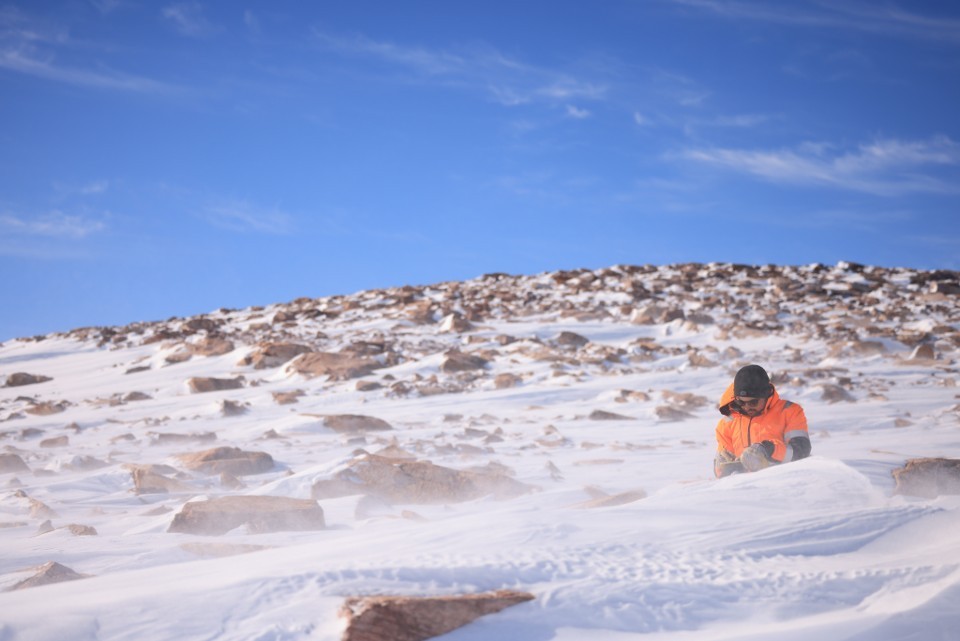 Walcott-George taking notes on a glacier in Greenland.